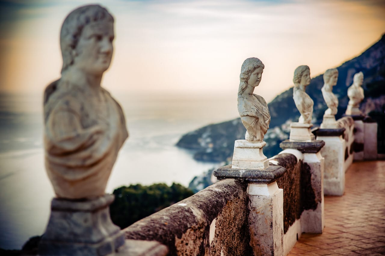 Een sfeervol diner op een schilderachtig terras met uitzicht op de Amalfi kust, gedecoreerd met kaarsen en bloemstukken.